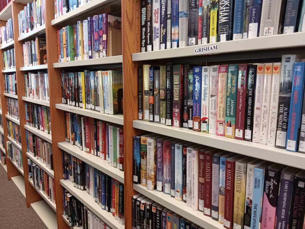 A close up view of books on library shelves.